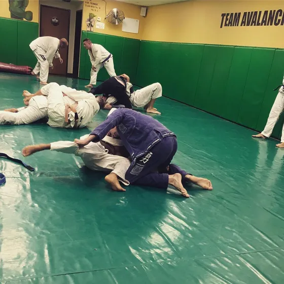Adult students sparring during a Brazilian Jiu-Jitsu class