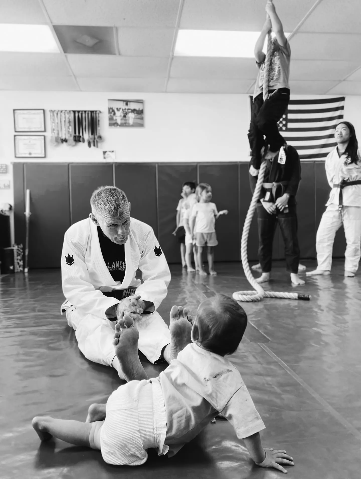 Professor James Boran sitting with young students during a class